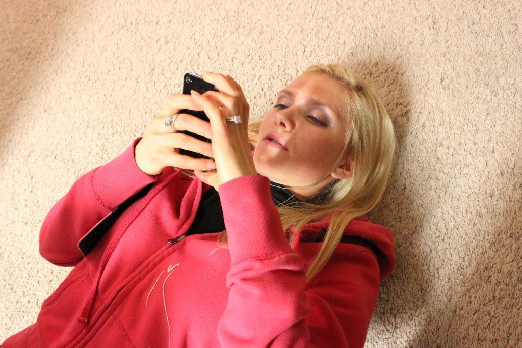 on the floor on the phone